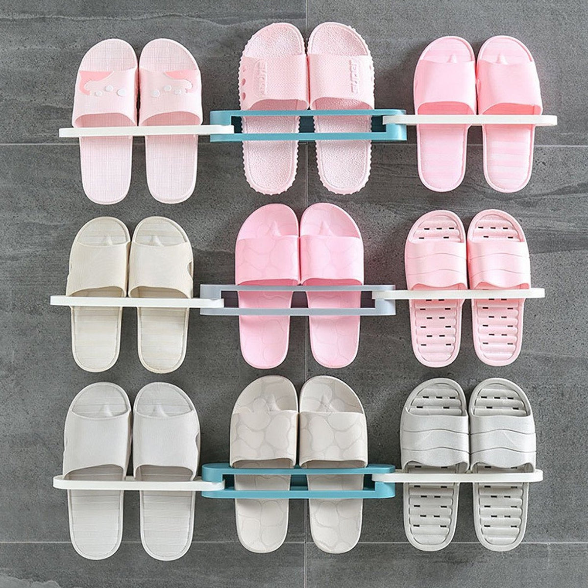 Nine pairs of pink, beige, and gray slippers are organized on three folding racks against a gray tiled wall.