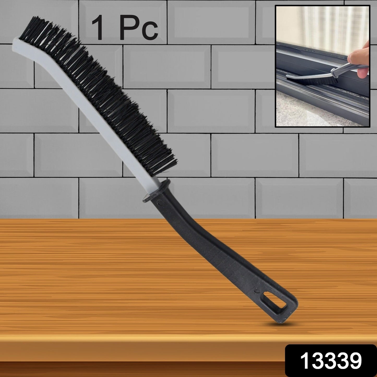 A black and gray crevice cleaning brush stands upright against a gray tiled wall, with an inset showing it cleaning a window