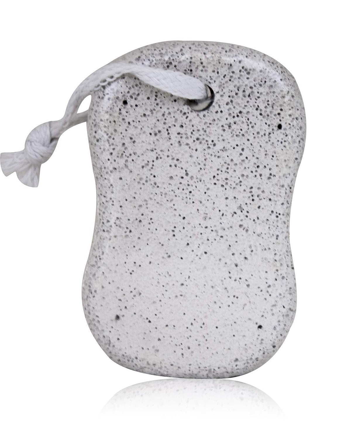 A grey, porous pumice stone with a white rope attached, casting a reflection on a white surface.