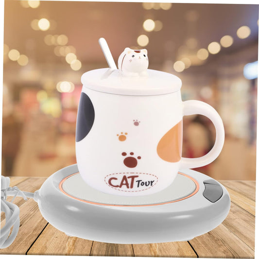 USB mug warmer keeping a coffee cup warm on a wooden desk.