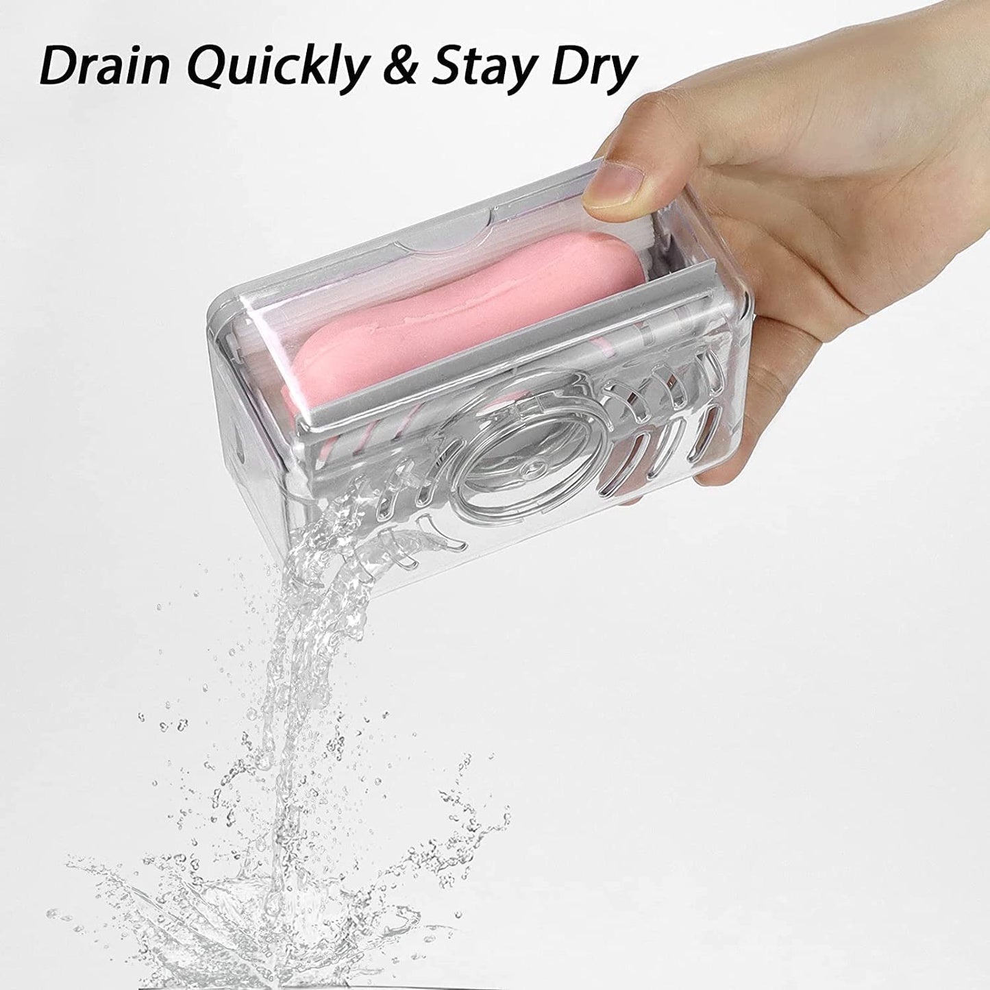 A hand holds the clear soap dispenser, draining water from a pink soap bar inside.