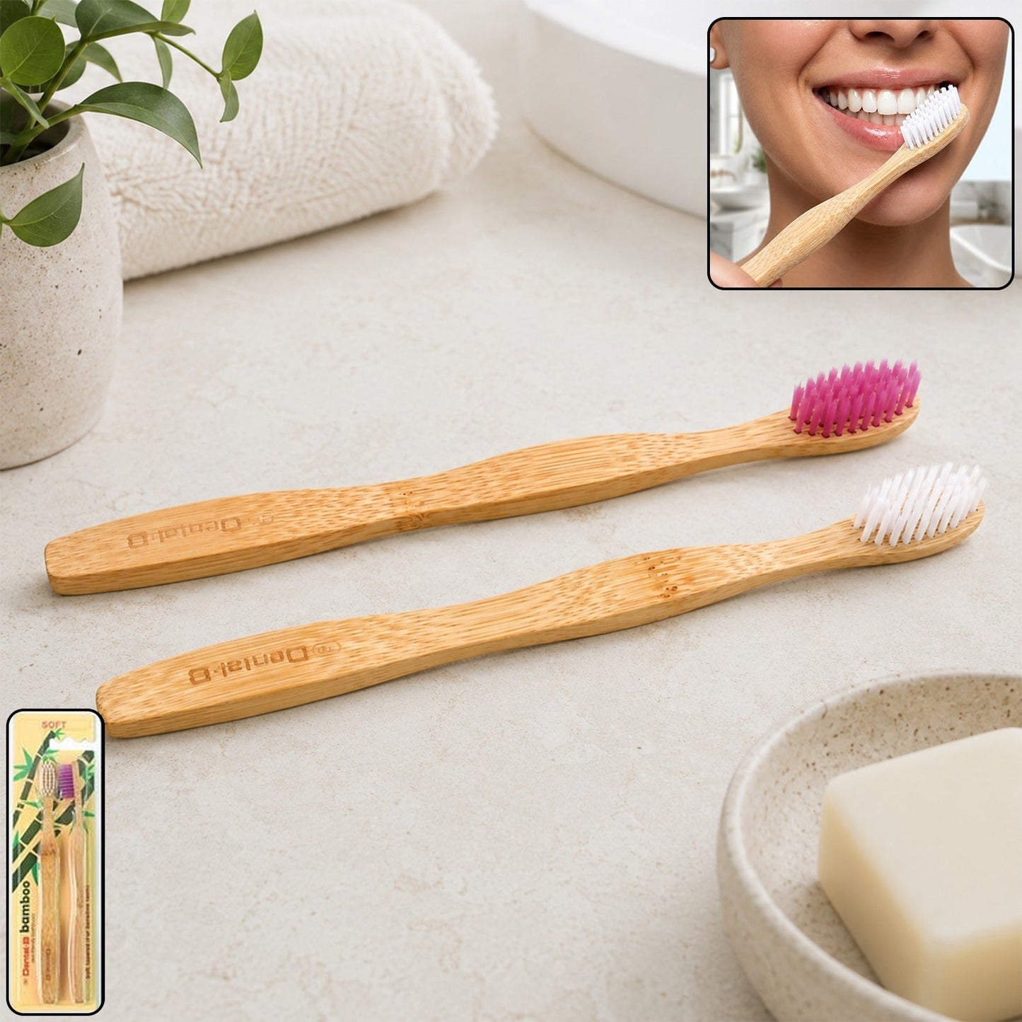 Two bamboo toothbrushes, one with pink bristles and one with white, on a bathroom counter with a person brushing their teeth