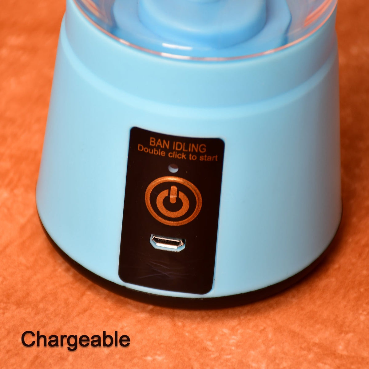 A close-up of the light blue base of the portable juicer blender shows its power button and USB charging port.