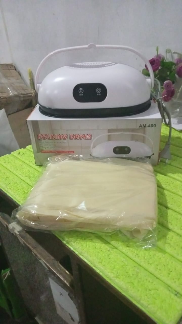 Compact foldable portable clothes dryer, perfect for travel convenience.