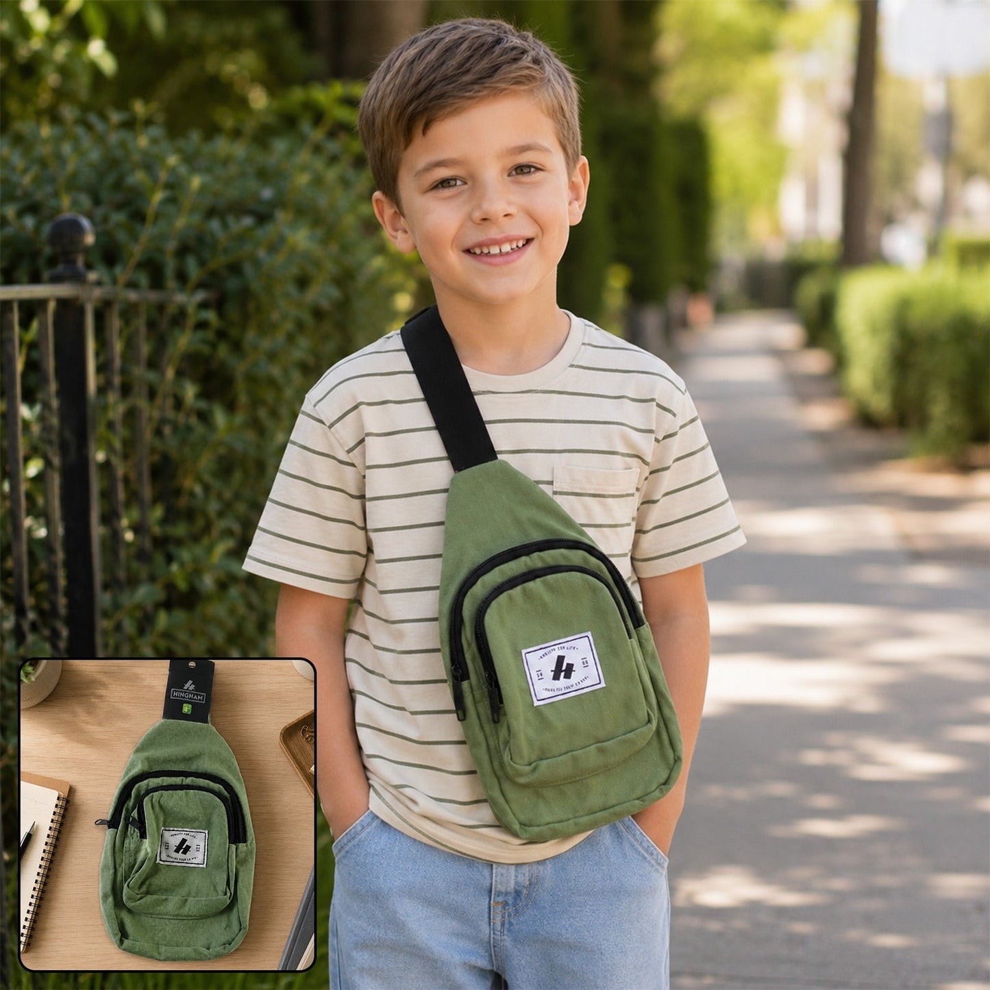 A smiling boy wears an olive green canvas sling bag with a black strap over his shoulder, walking outdoors.