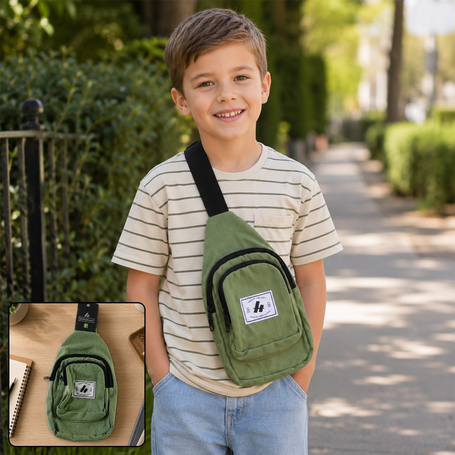 A smiling boy wears an olive green canvas sling bag with a black strap over his shoulder, walking outdoors.