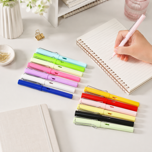 A hand writes with a pink inkless pencil on a notebook, surrounded by other colorful pencils.