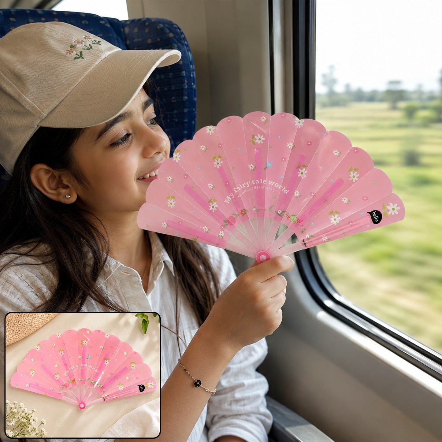 A young girl in a train holds a pink floral fan open, looking out the window; a smaller inset shows the fan closed.