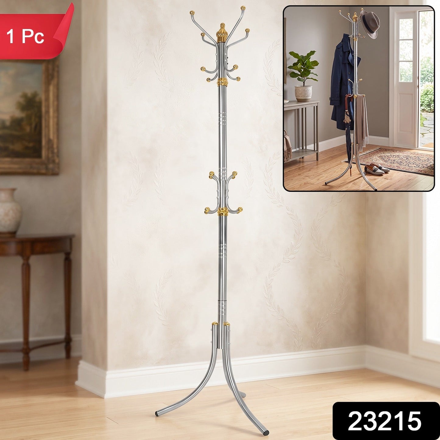 A silver-colored metal clothes hanger stand with gold accents and multiple hooks stands in a room with a painting and a side