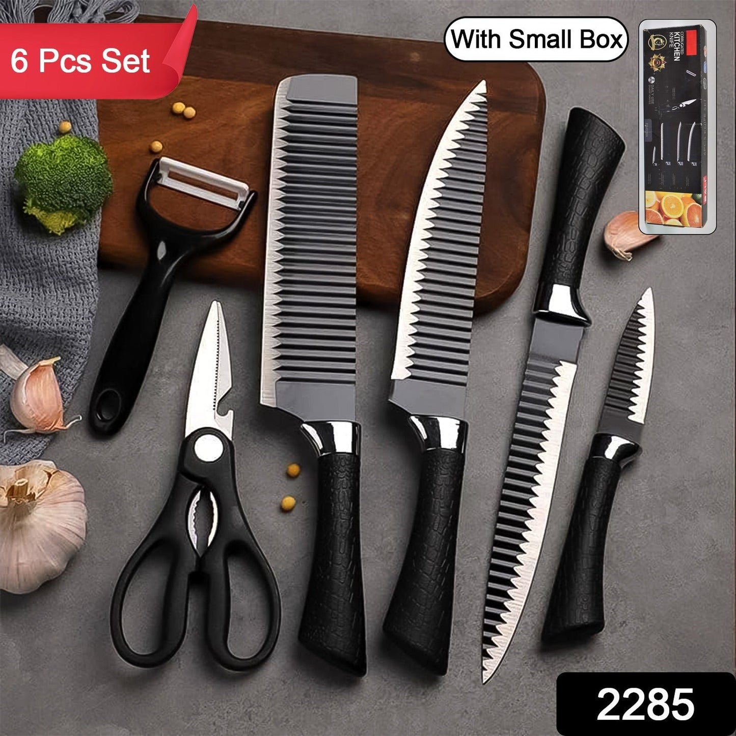 Six-piece black serrated knife set with peeler and scissors on a wooden cutting board with garlic.