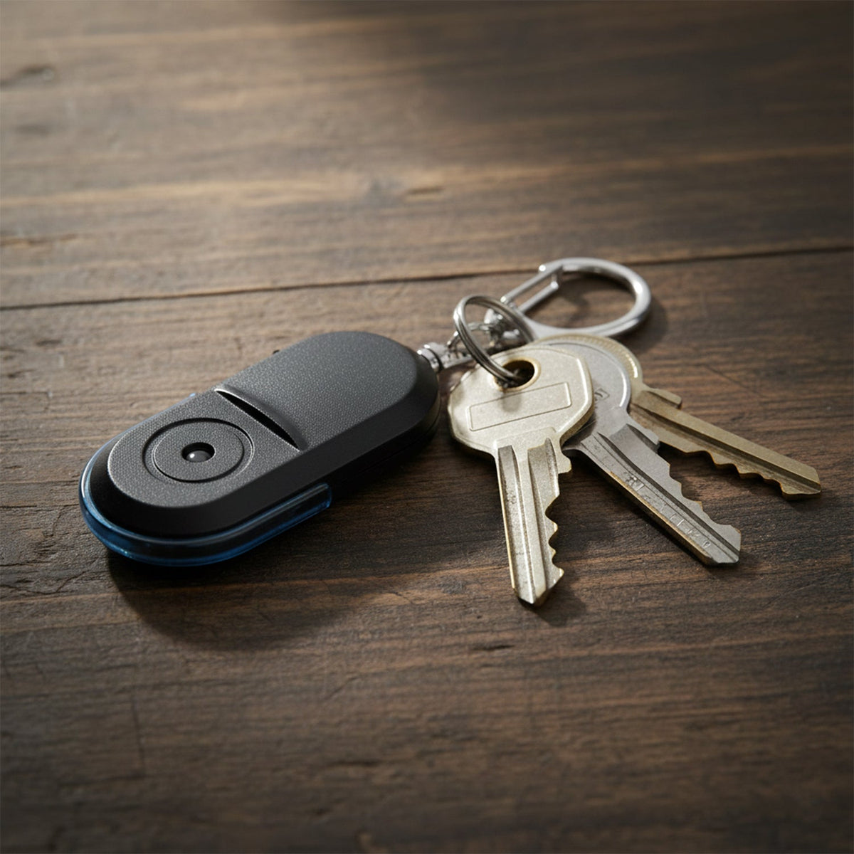 The back of a black and blue personal safety alarm keychain with a silver carabiner clip is shown on a white background.