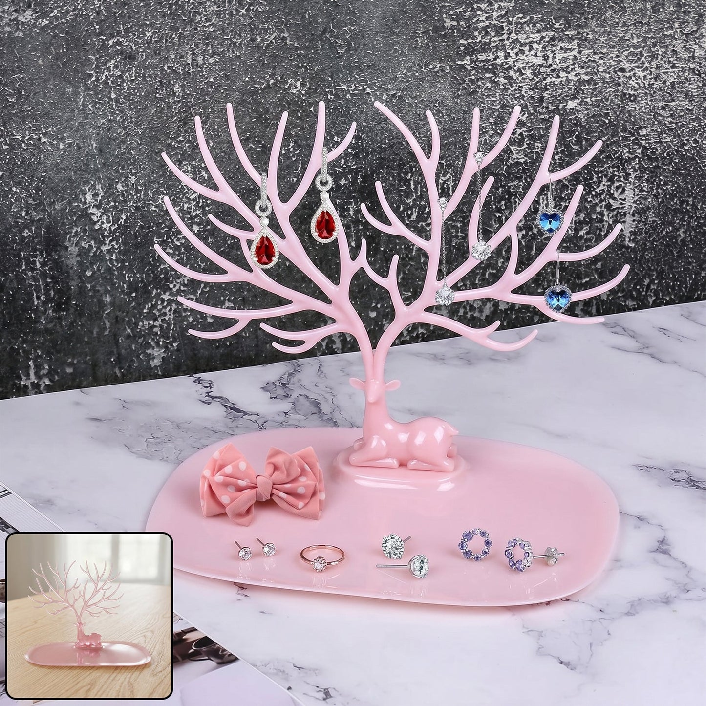 Pink deer-shaped jewelry stand with tree branches for earrings and rings, India