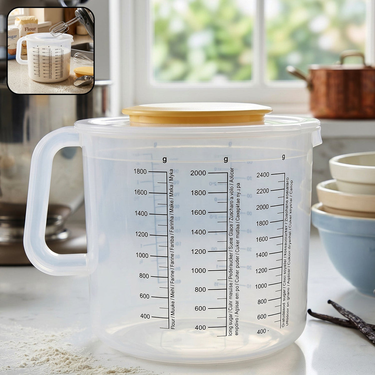 A clear plastic measuring jug with a yellow lid, set on a kitchen counter with baking ingredients.