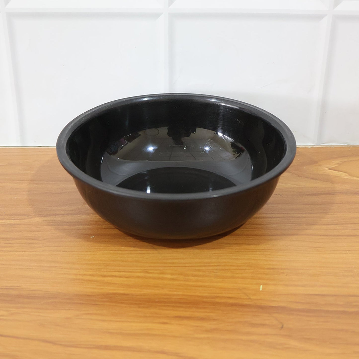 Close-up of texture on black plastic serving bowl
