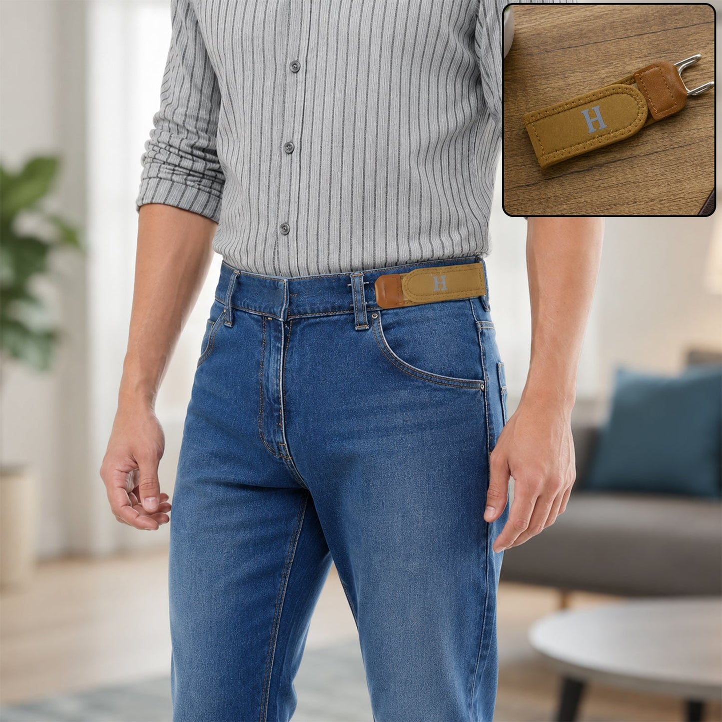 A man in a striped shirt and blue jeans wears a tan buckle-less belt with a silver 'H' on the front, with a close-up of the