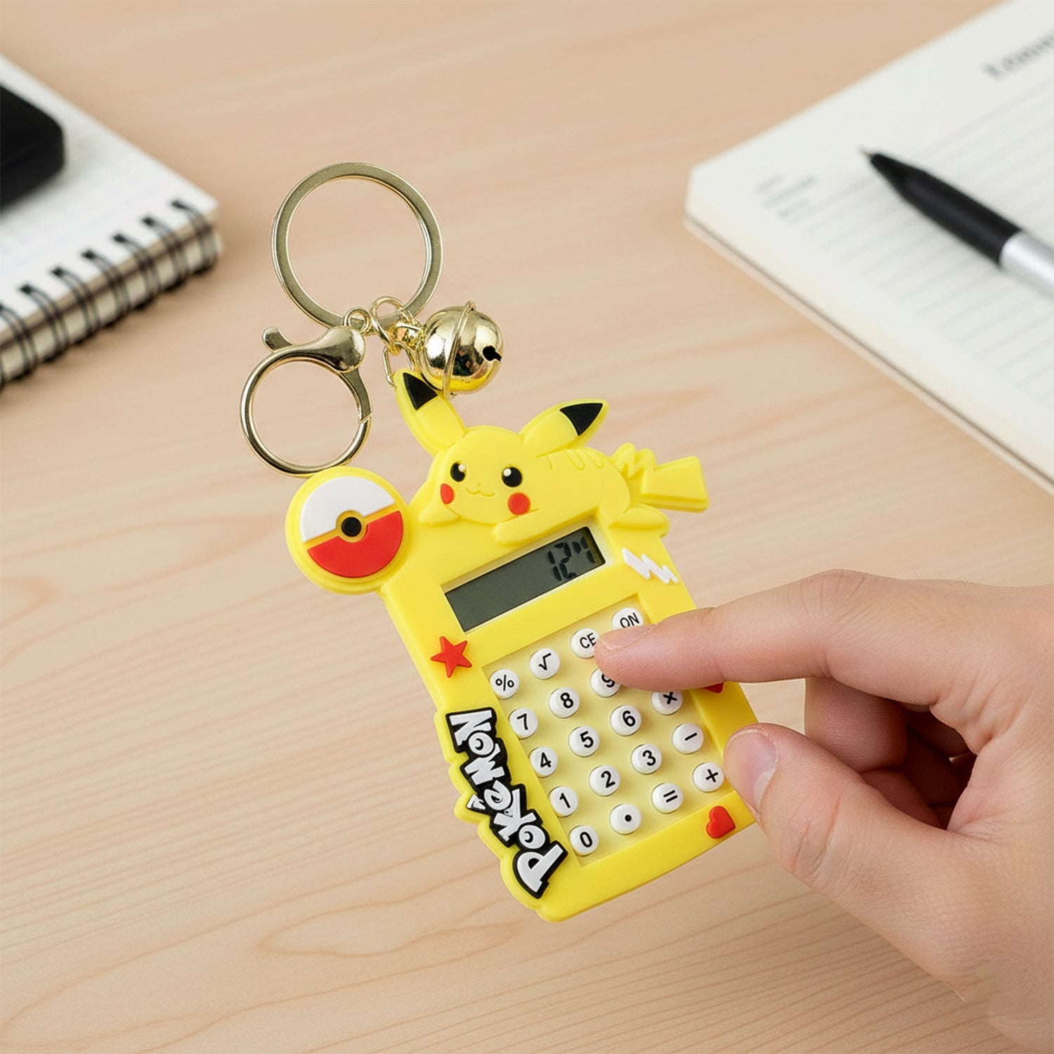 Cartoon keychain calculator with bright yellow character and metal ring bell charm