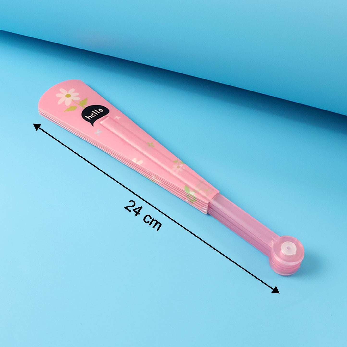 A closed pink fan with a white flower and background