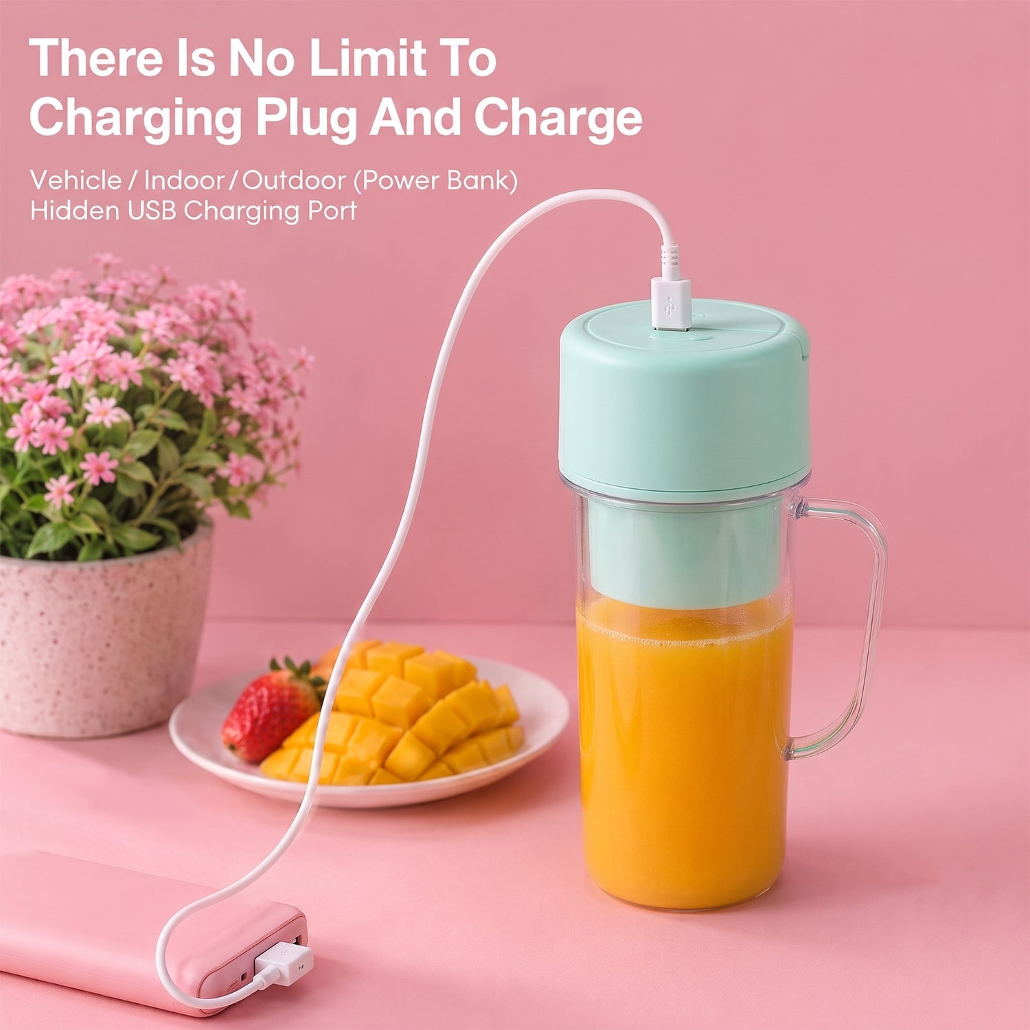 A clear blender bottle with orange juice and a mint green lid is charging via a white USB cable from a pink power bank.