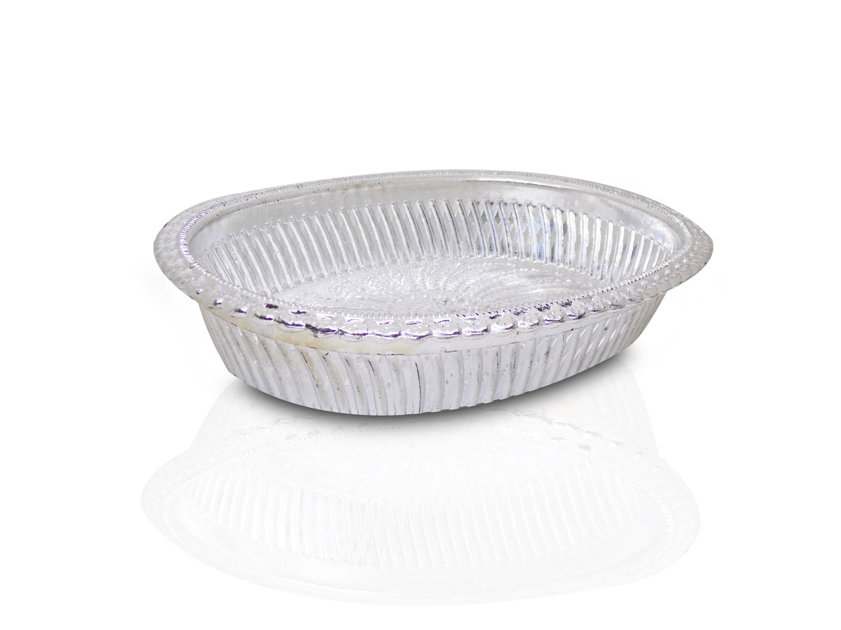 A silver oval decorative serving tray with a floral pattern on a white background with a reflection.