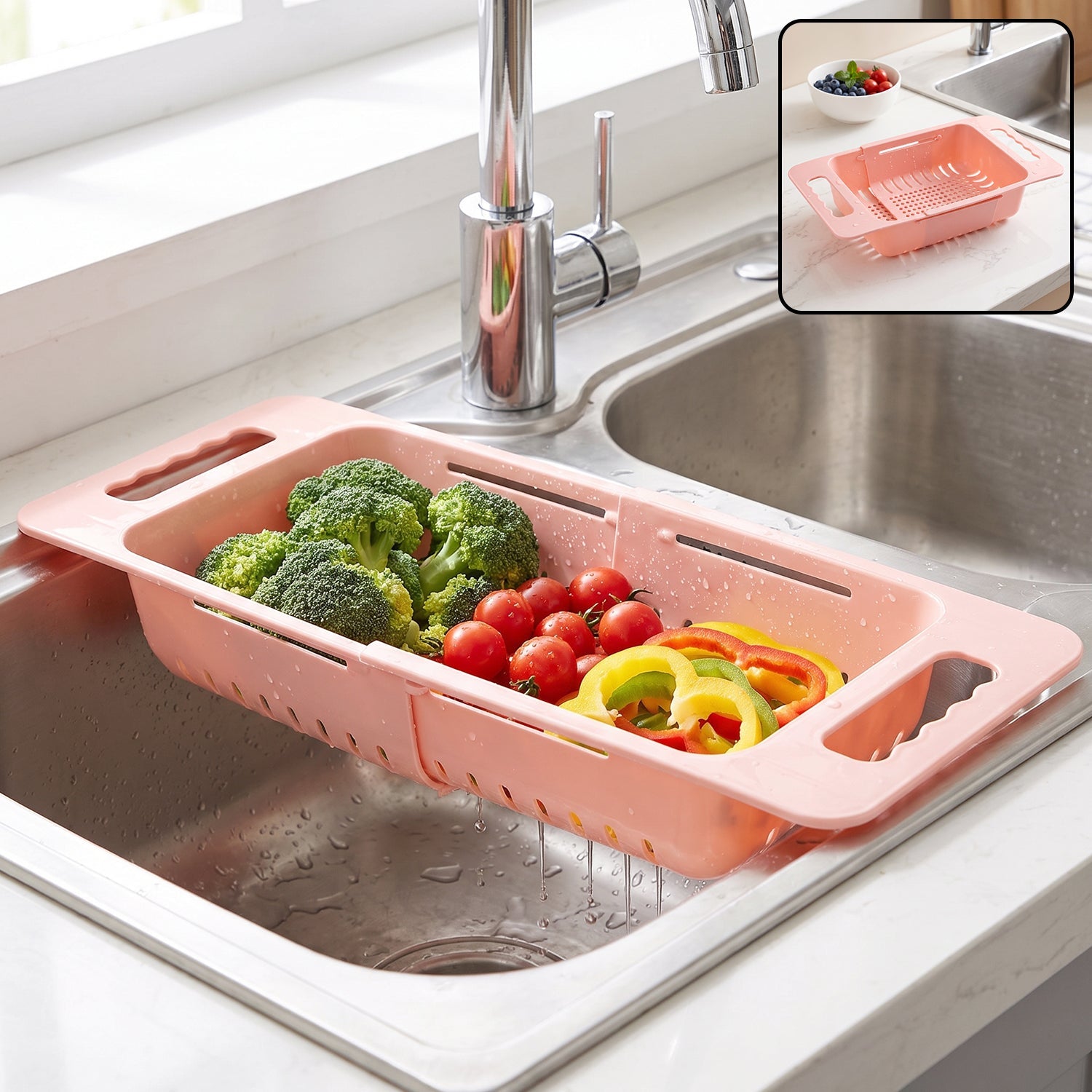 Pink plastic adjustable over-sink drain basket with broccoli, tomatoes, and bell peppers in a kitchen sink, with an inset
