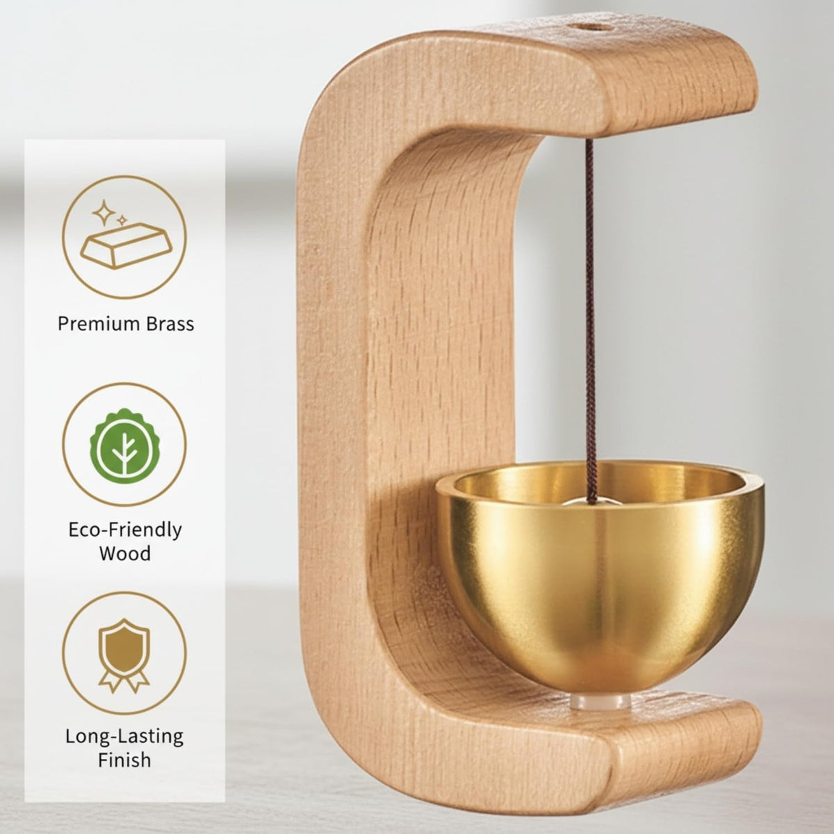 A light wood C-shaped door chime with a golden bowl and striker, with text highlighting premium brass, eco-friendly wood,