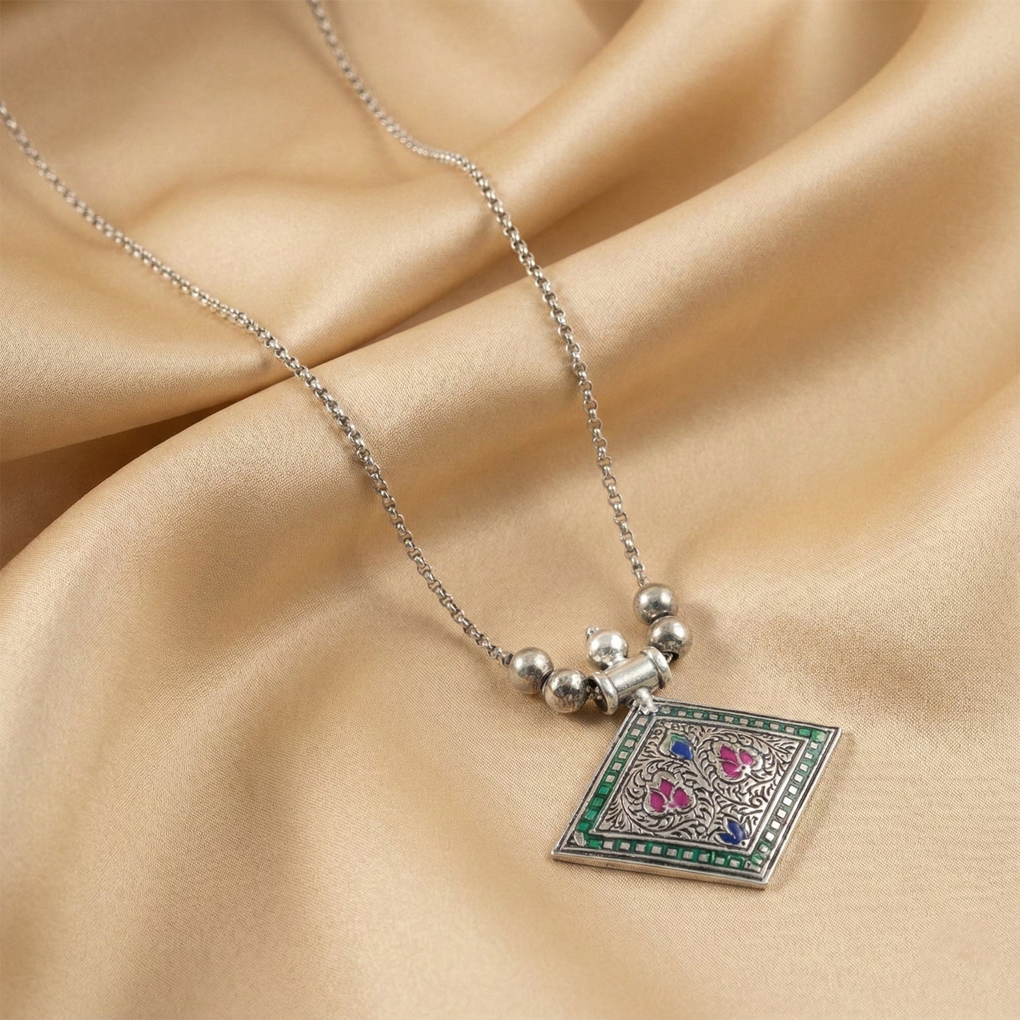 Traditional oxidised silver pendant necklace with square floral motif