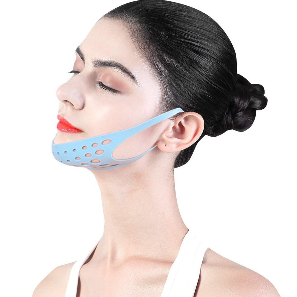 A woman with her eyes closed wears a blue silicone chin and ear strap, with her hair pulled back.