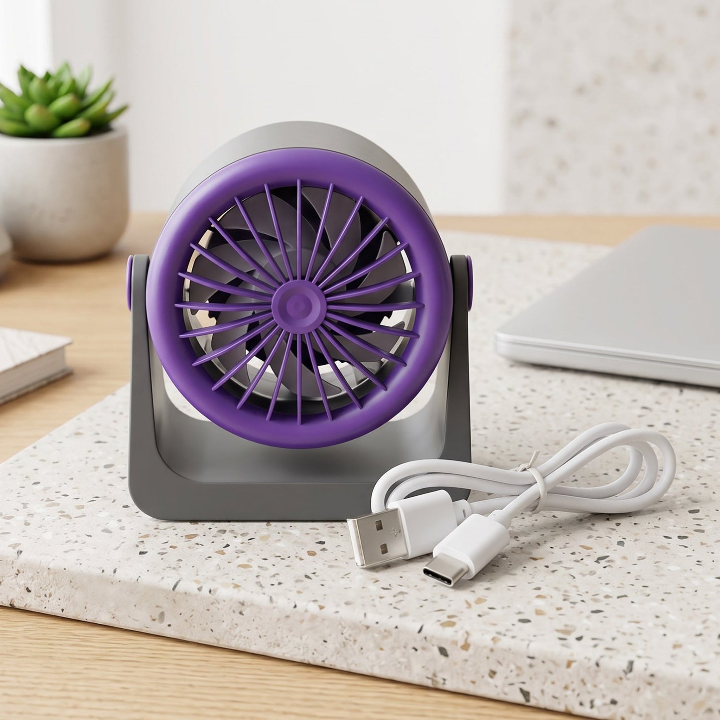 A woman smiles while adjusting the gray and purple Personal Desktop Air Circulation Fan on her desk.