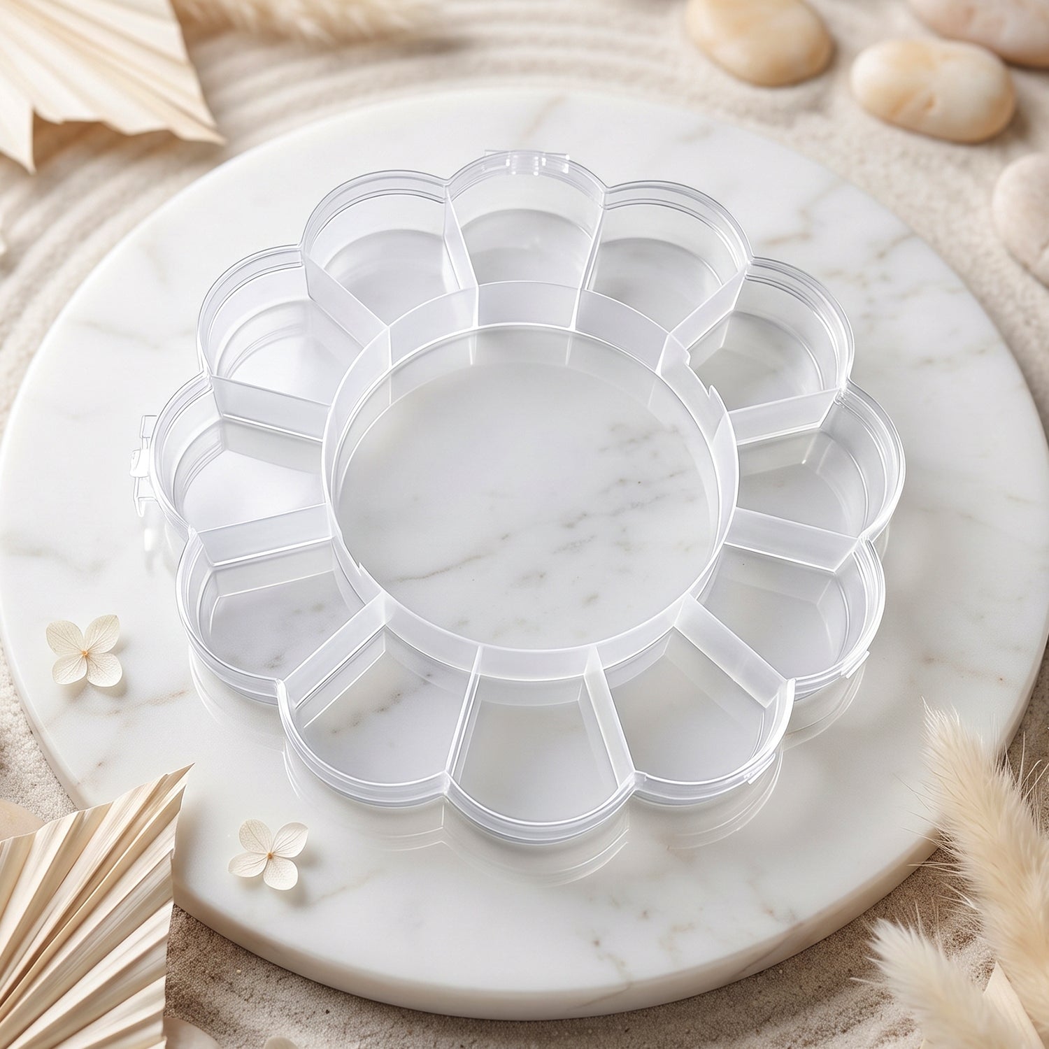Empty clear flower-shaped plastic organizer box with 13 compartments on a white marble tray with decorative elements.