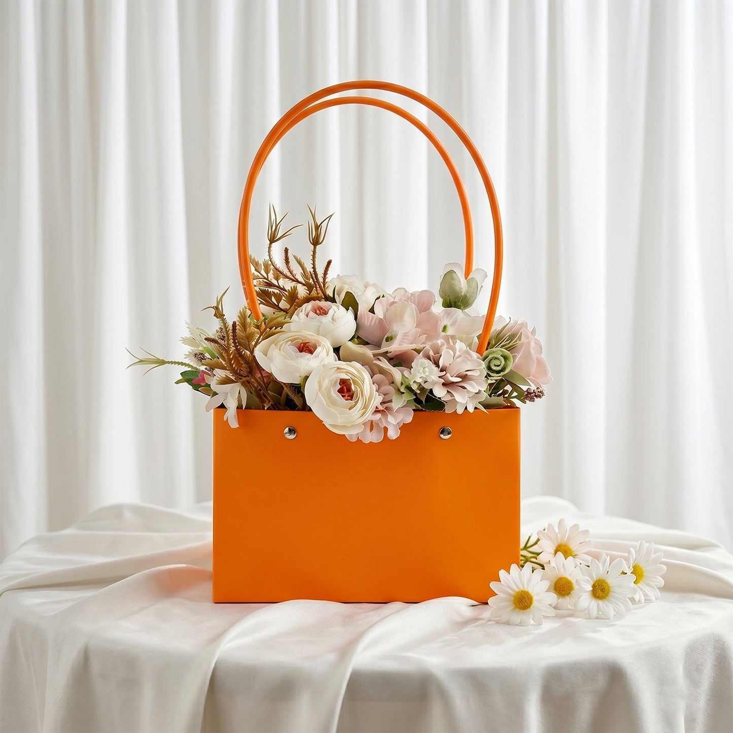 Orange flower gift bag filled with pink roses and artificial flowers for gifting