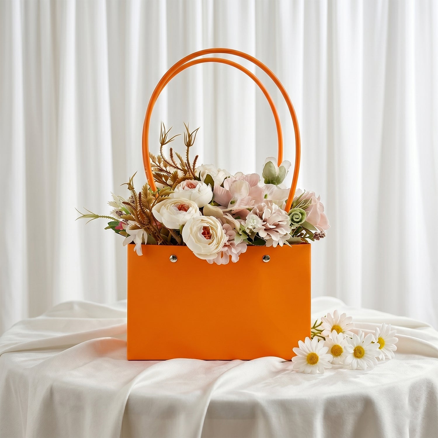 Orange flower gift bag filled with pink roses and artificial flowers for gifting