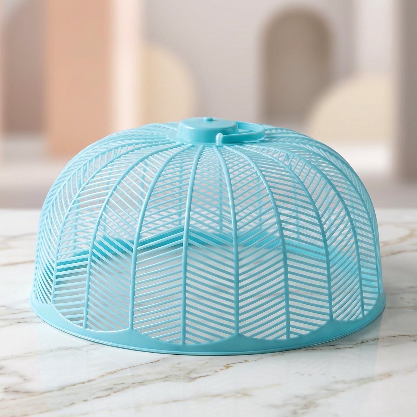 Close-up of a light blue plastic mesh food cover dome on a marble surface.