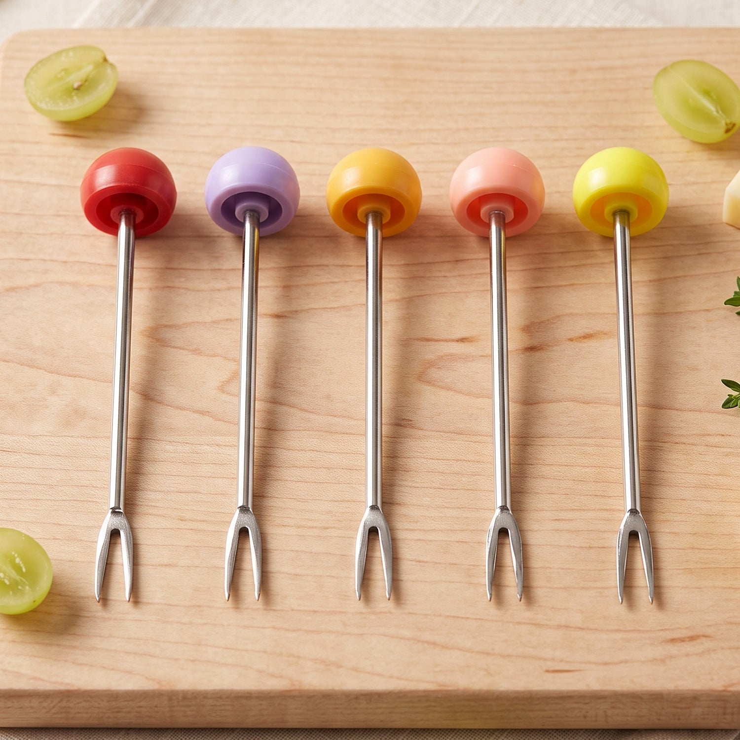 Fruit forks picking up cut fruit from a plate