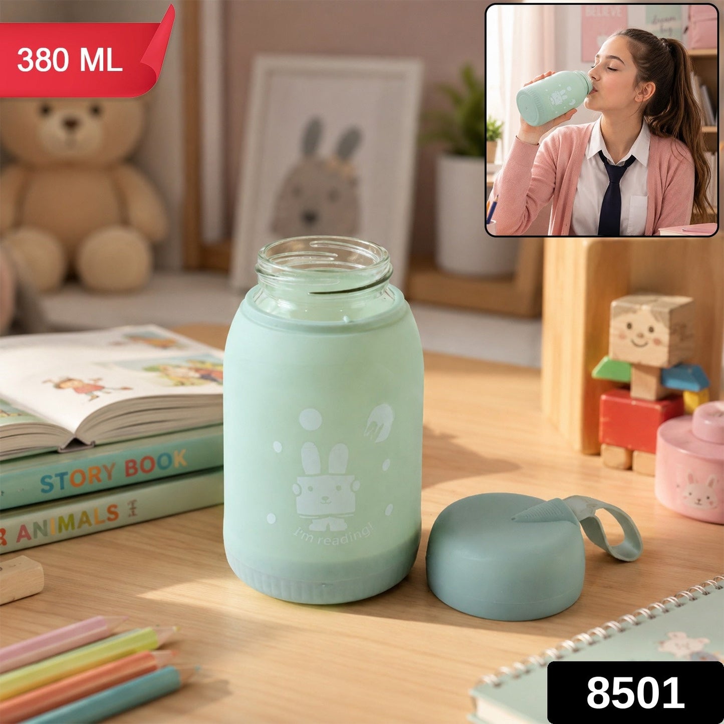 A mint green glass bottle with a bunny print sits on a desk, with a matching lid beside it. The bottle is labeled 380 ML and