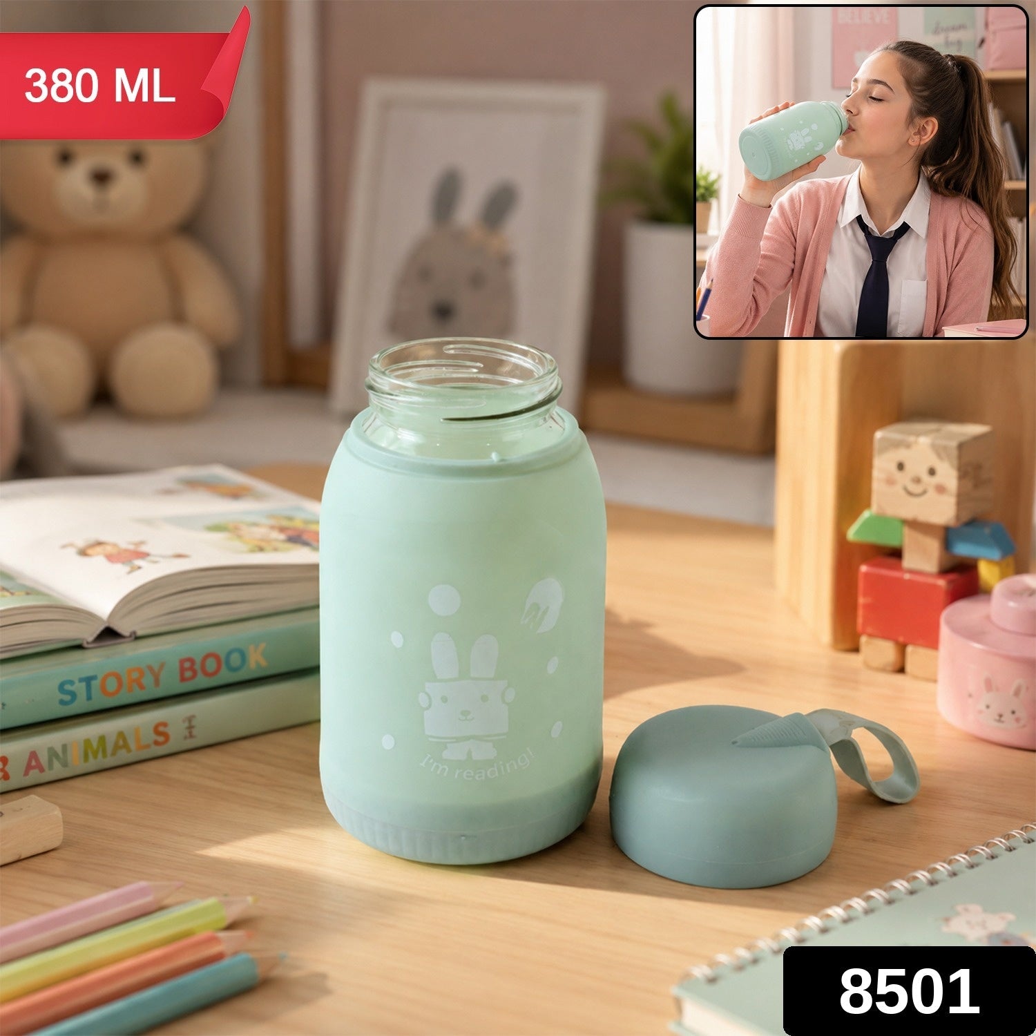 A mint green glass bottle with a bunny print sits on a desk, with a matching lid beside it. The bottle is labeled 380 ML and