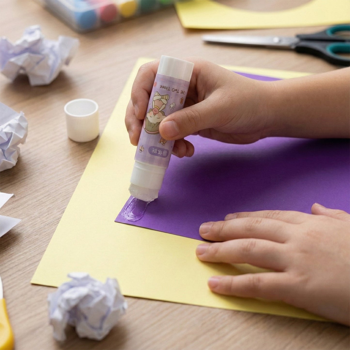 Smooth application of solid glue stick on paper for crafts