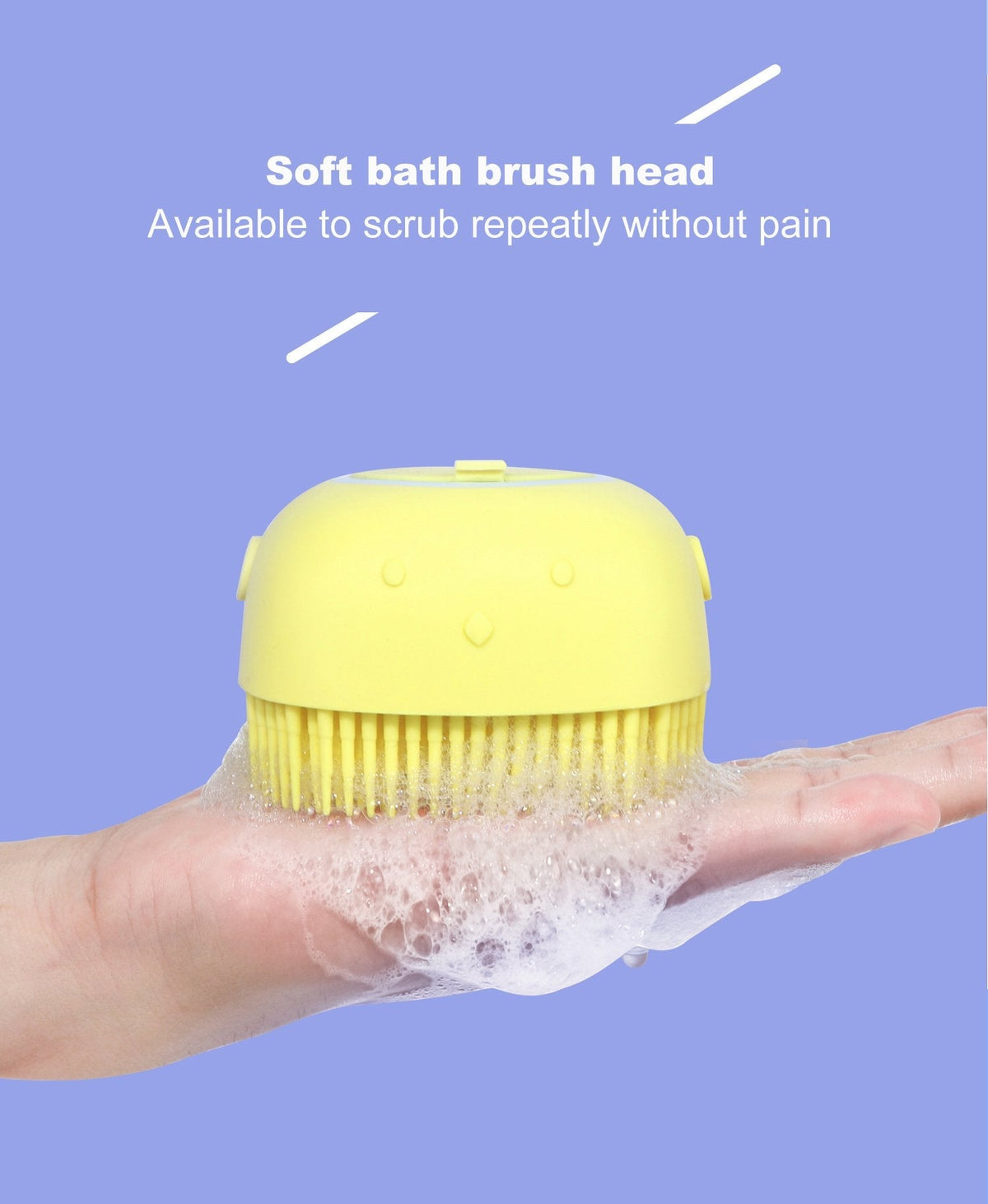Yellow silicone bath brush with shampoo dispenser held in a hand with suds, on a purple background.