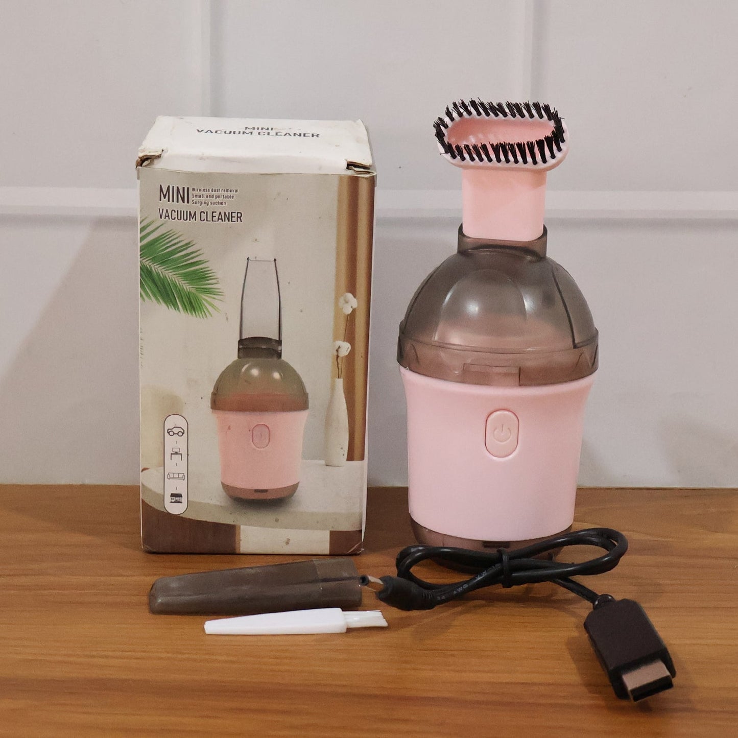 Mini vacuum cleaner in use on various surfaces
