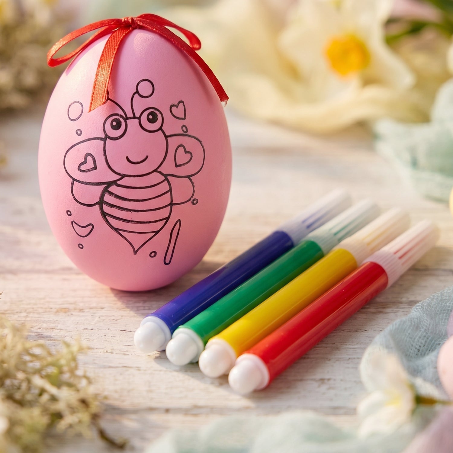 Colorful pens and decorative egg for kids’ art activities