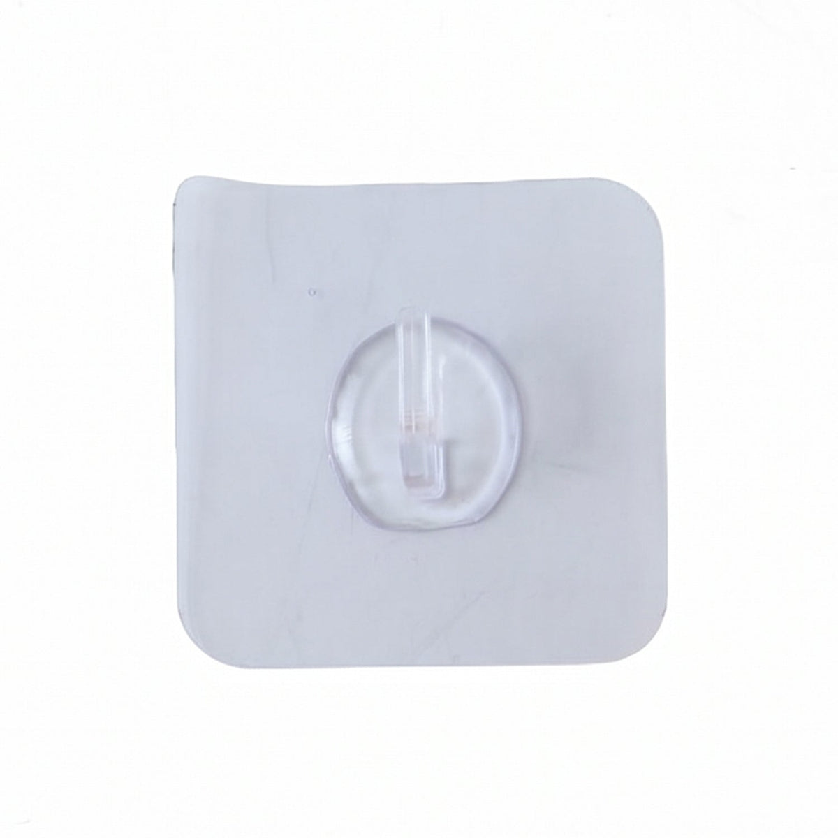 A close-up, top-down view of a single clear self-adhesive wall hook on a white background.