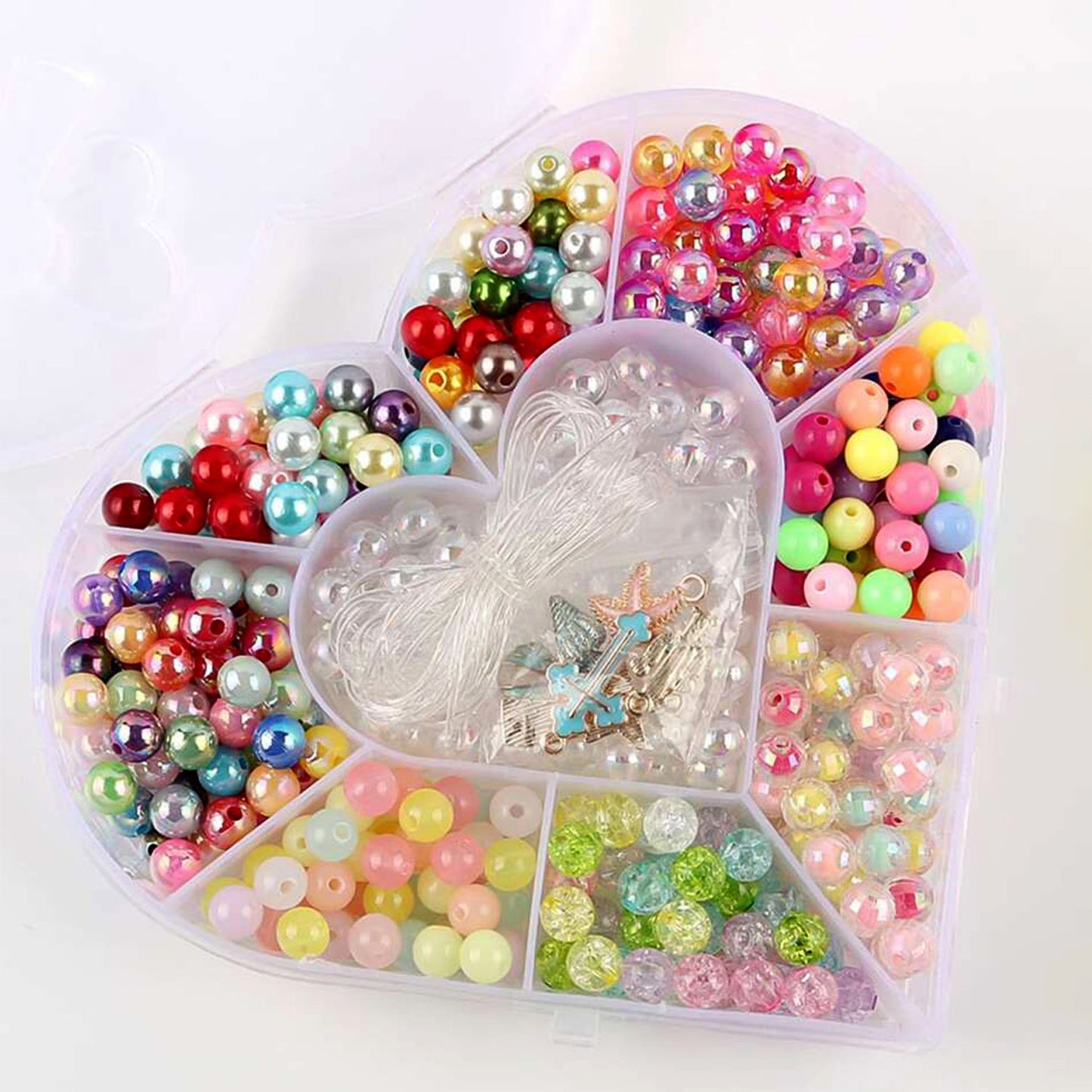 Detail of heart-shaped plastic bead storage box showing bow design lid
