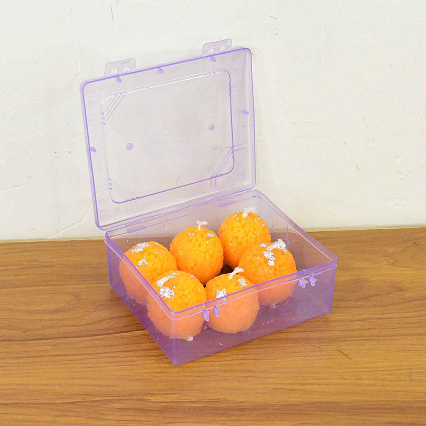 Decorative laddu shaped wax candles displayed as Diwali and festival lighting