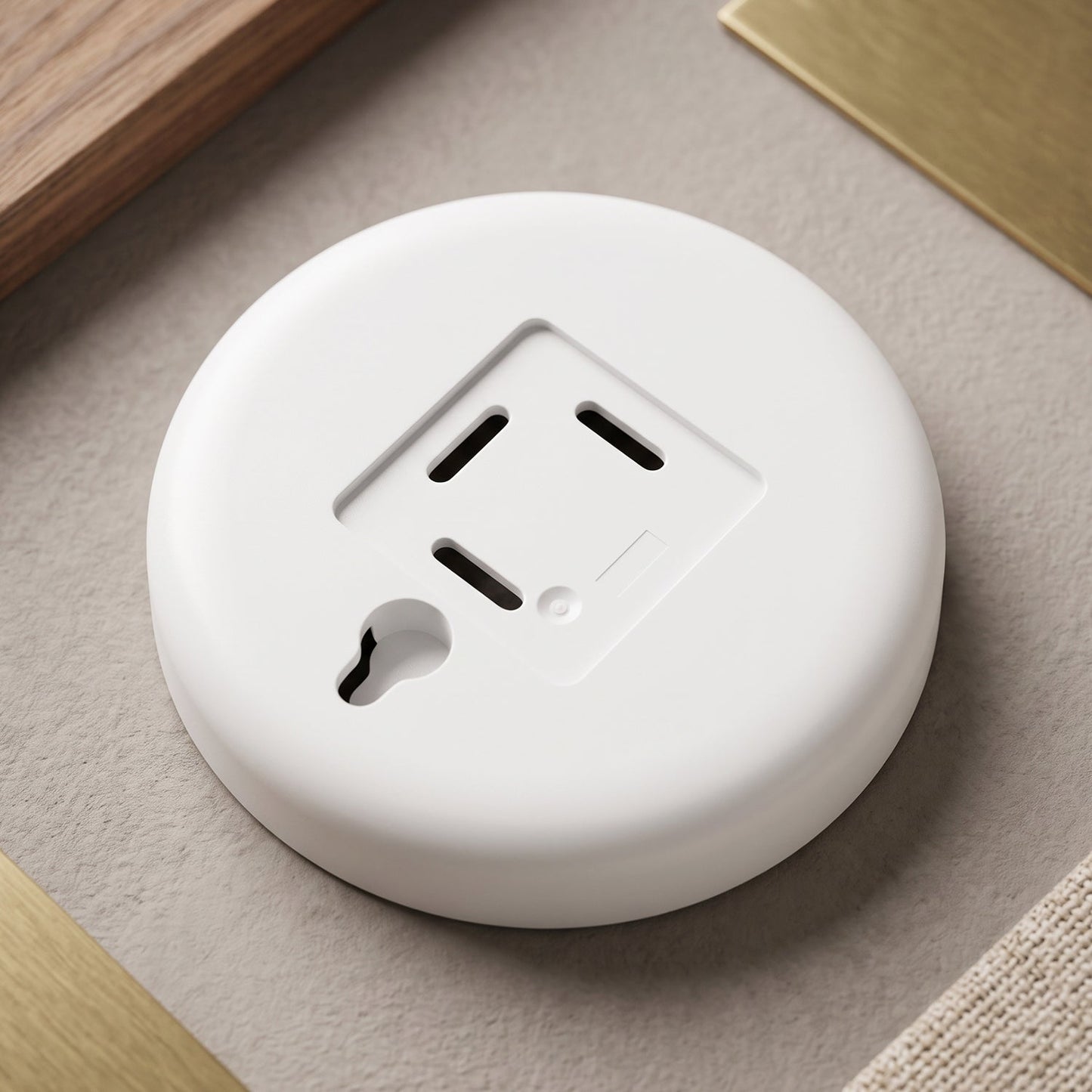 The back of the white circular LED light features a power outlet design and a keyhole slot for mounting.