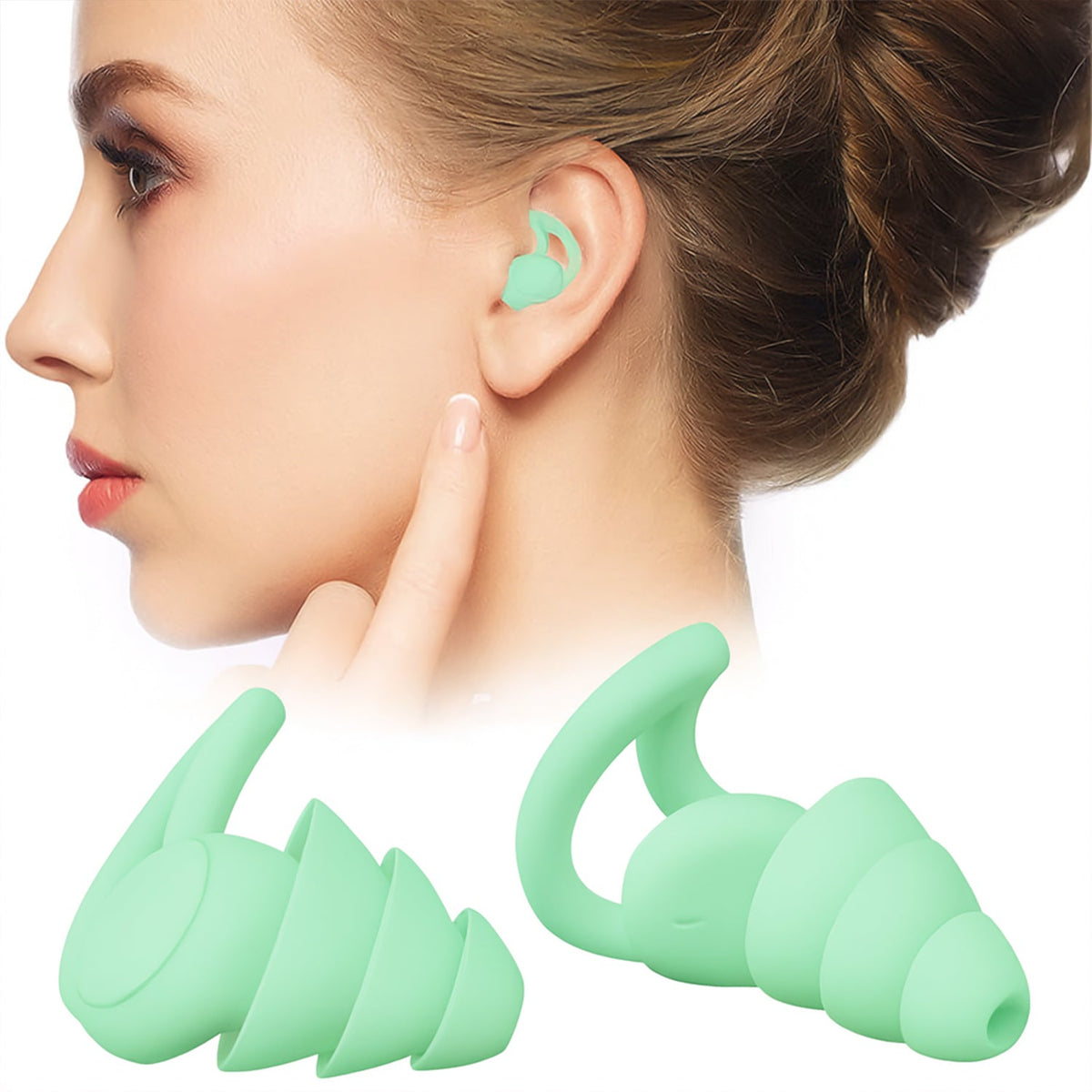 A woman wears a mint green earplug, with a larger pair of the same earplugs displayed in the foreground.