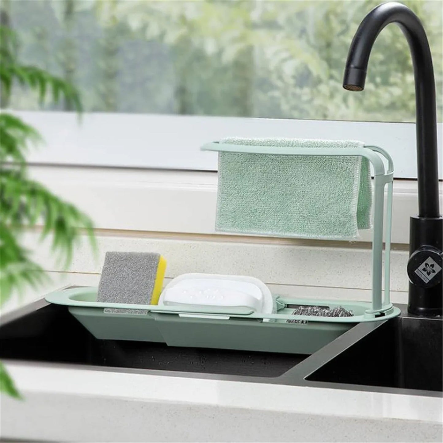 Telescopic sink caddy rack holding multiple kitchen cleaning supplies