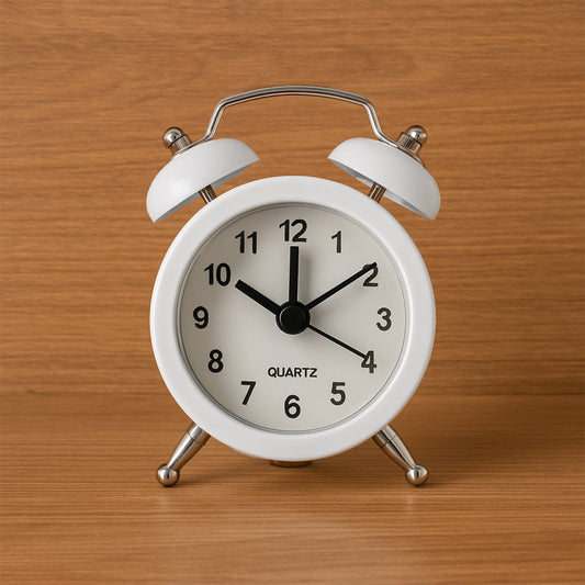 Close-up of a classic twin-bell analog alarm clock face.