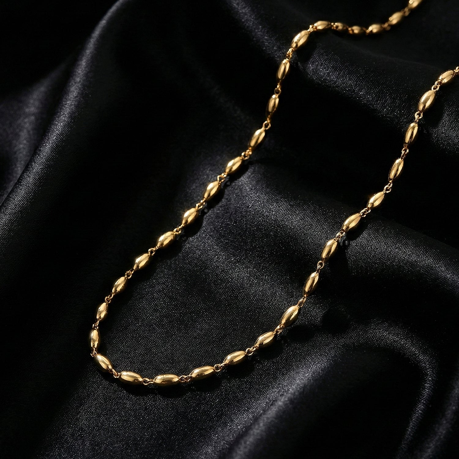 Trendy gold tone oval bead necklace enhancing festive attire