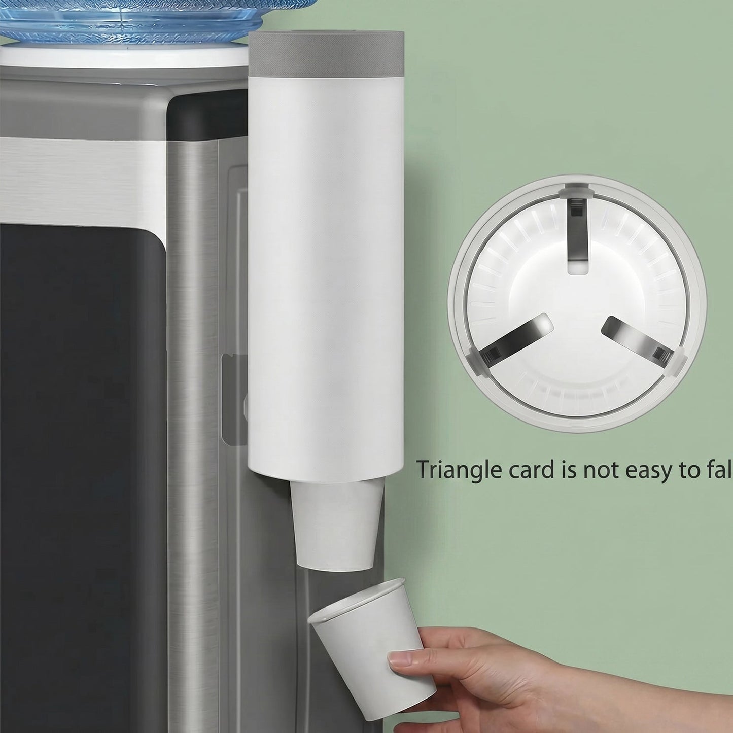 A white cup dispenser mounted next to a water cooler, with a hand taking a cup, and an inset showing the cup holder's