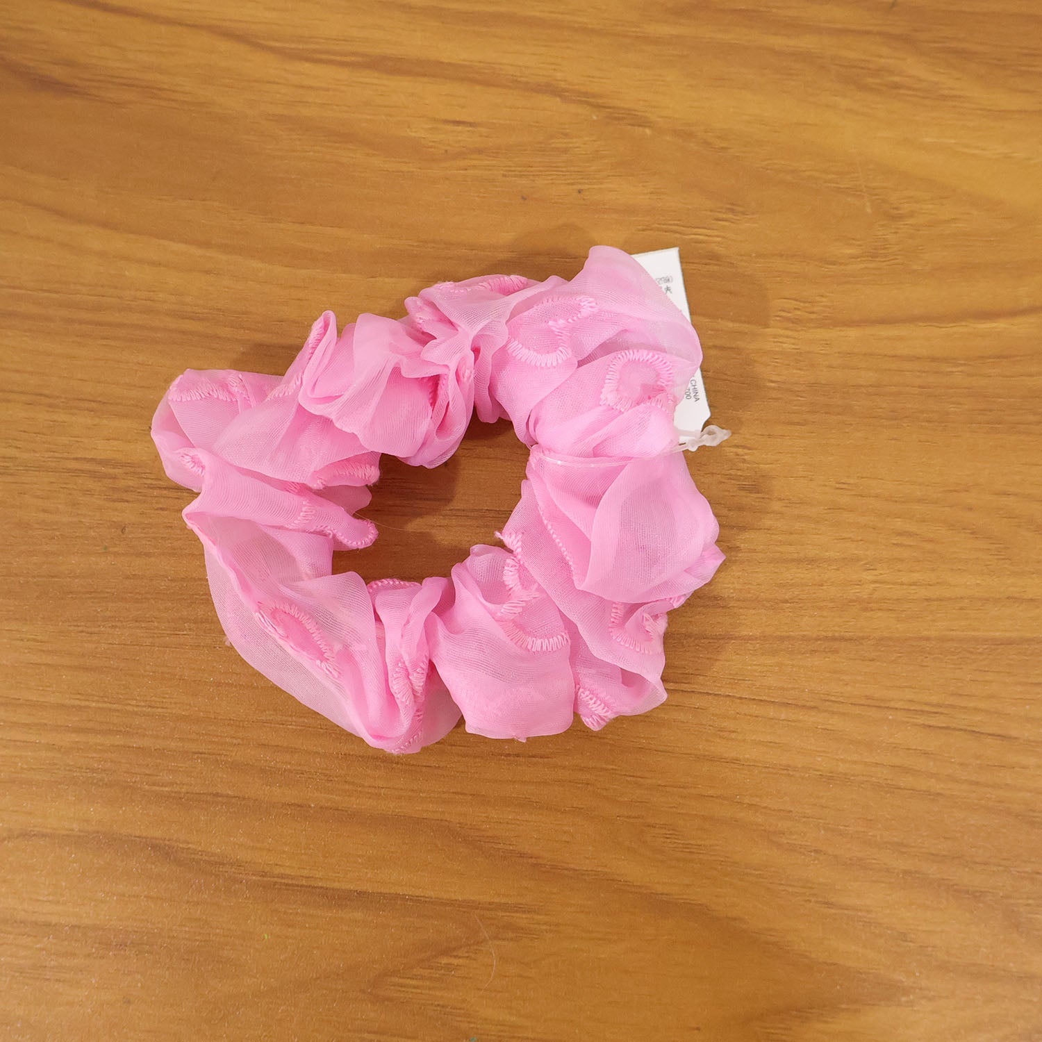 Soft pink elastic hair scrunchie for versatile hairstyles