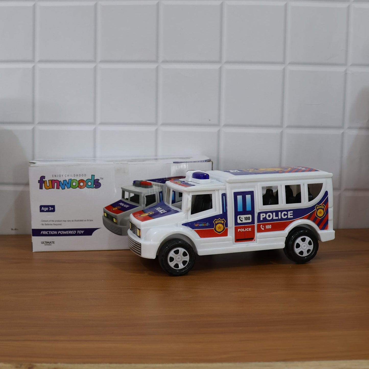 Child playing with the Police Van Toy demonstrating friction powered movement